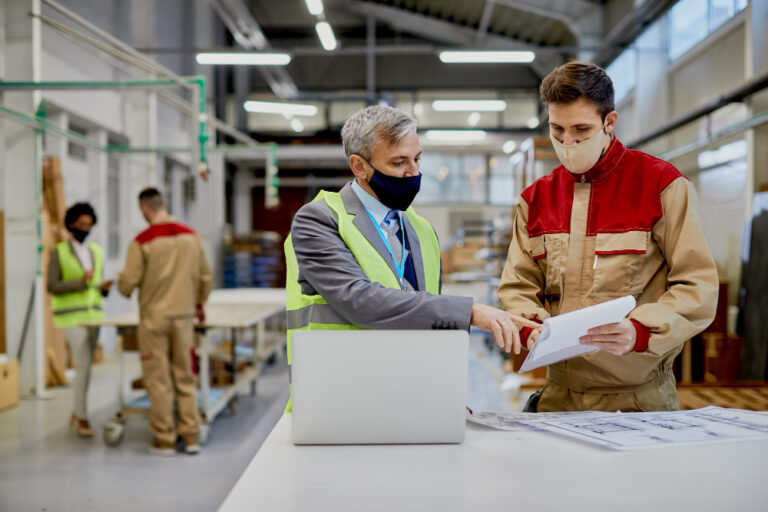 mid-adult-engineer-male-worker-wearing-face-masks-while-examining-paperwork-woodworking-factory